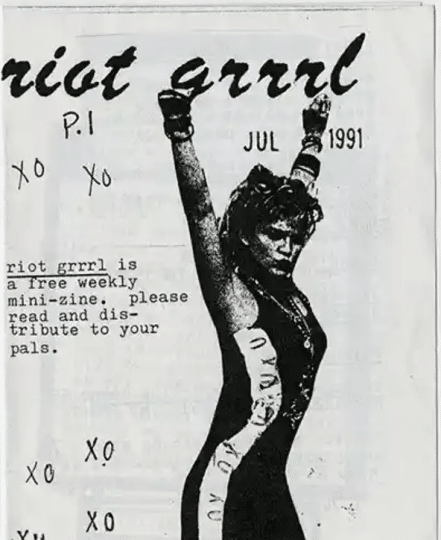 Cover of the first Riot Grrrl zine from July 1991. The cover is in black and white and features a woman raising her arms.